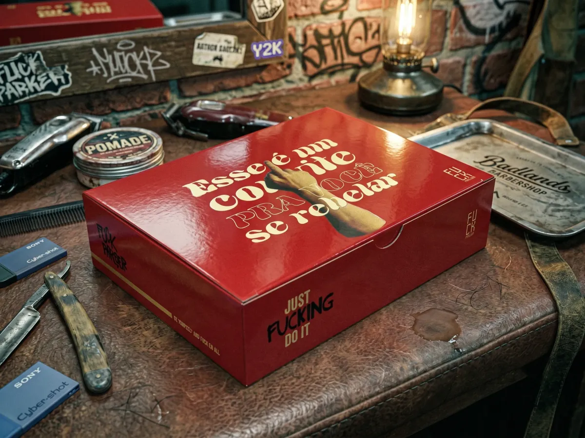 Red FK Parlour box, “Esse é um convite pra você se rebelar”, on a barber’s workbench